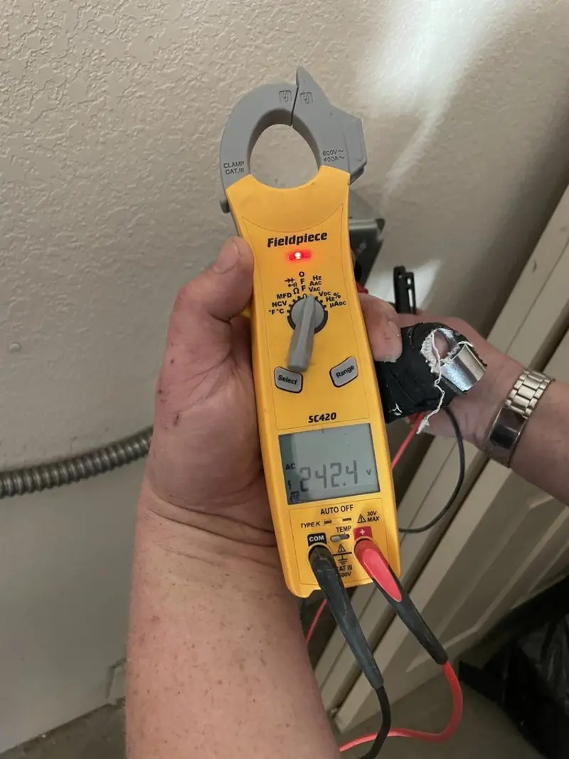 Voltage testing with clamp meter during Outlet Installation in Lima